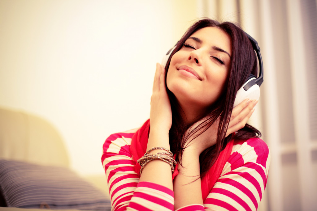 Young woman wearing bright outfit enjoying music 